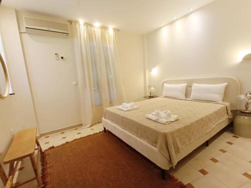 a bedroom with a bed with two towels on it at Sea Sun in Plomari