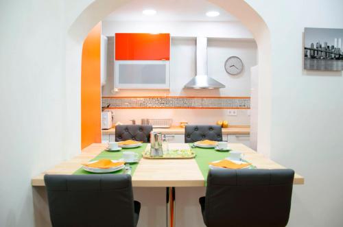 a kitchen with a table and chairs in a kitchen at Oscar Apartments Estación in Sitges