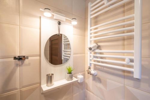 a bathroom with a mirror and a sink at Zvjezdana dolina Garni hotel in Andrijevica