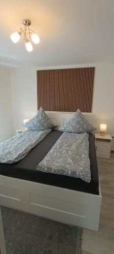 a bed with two pillows on it in a room at Stilvolle Wohnung in Waldbrunn in Waldbrunn