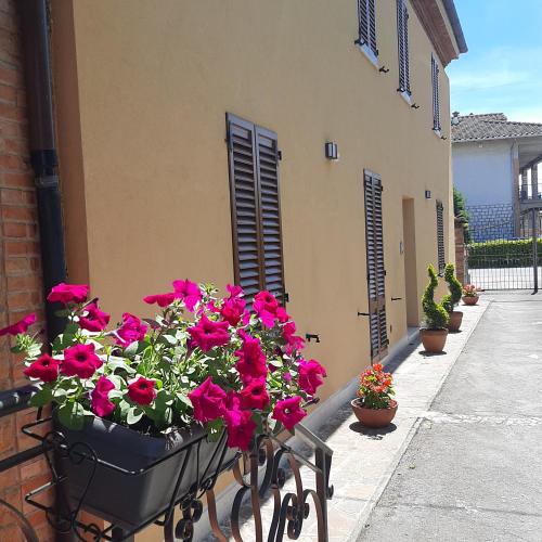 a bunch of flowers in a basket on a balcony at Tuscany Hills - Comfort 10 minutes from Montepulciano and Pienza in Torrita di Siena