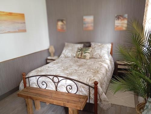 a bedroom with a bed and a wooden bench at La Planoise in Autun