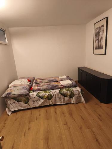 a bedroom with a bed and a dresser at Motoráj -apart Kutná Hora in Kutná Hora