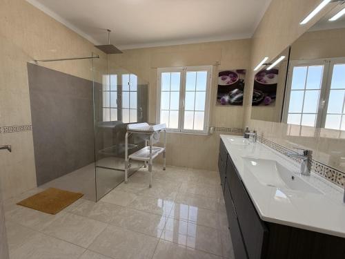 a bathroom with a glass shower and a sink at villa piscina y vistas espectaculares a la montana , gran terraza y aire acondicionado in Cuevas del Almanzora