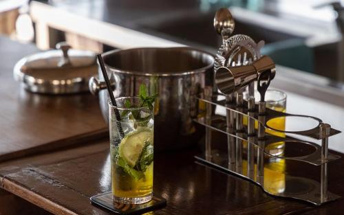 a drink in a glass on a table with a juicer at Posho Sunset Mara in Sekenani