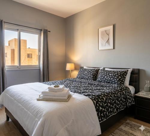 a bedroom with a bed with towels on it at appartement chaleureux in Oran