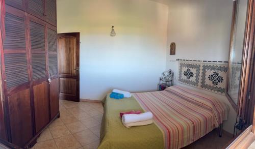 a bedroom with a bed with two towels on it at Villa Relax in Santa Lucia