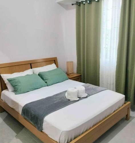 a bedroom with a bed with two towels on it at Homey Studio Apartment in Mandaue in Mandaue City