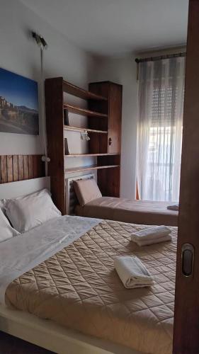 a bedroom with two beds and a window at Rustic Apartment with AC in Bergamo