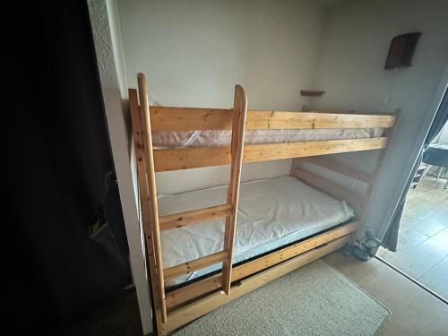 a wooden bunk bed in a room at Beau studio Pra loup 1500 in Pra-Loup