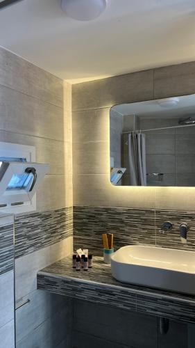 a bathroom with a sink and a mirror at Petradi Residence Sifnos in Platis Gialos
