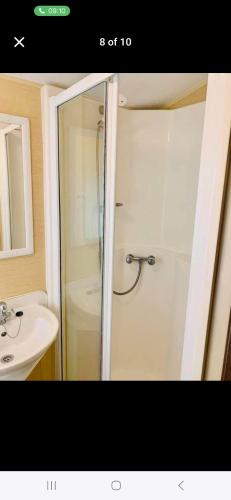 a bathroom with a shower and a sink at Caravan 63 Fishguard Holiday Park in Fishguard