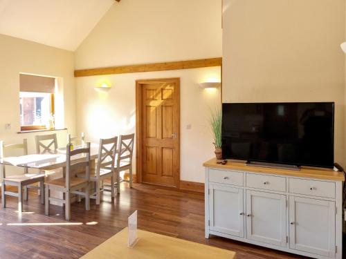 a living room with a large flat screen tv on a cabinet at Westfield Courtyard - Uk50704 in Garton