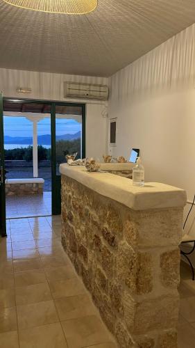 a stone bar in a room with a view at Niriides Rooms in Elafonisos