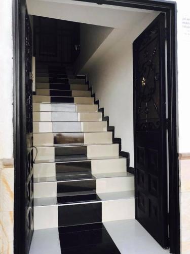 an open door to a staircase with black and white stairs at Hotel Mirador de Santa Bárbara in Socorro