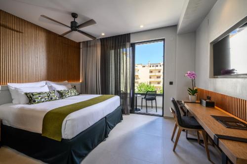 a hotel room with a bed and a desk and a desk at Anesea City in Heraklion