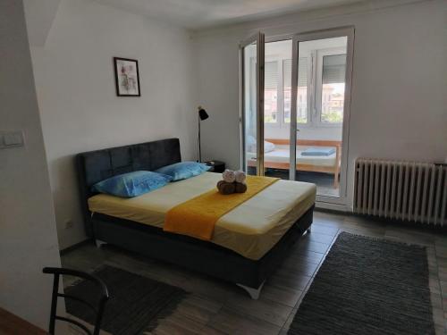 a bedroom with a bed with a teddy bear on it at City Nest in Vršac