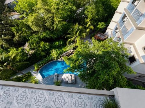 an overhead view of a swimming pool from a building at The Title Residencies Naiyang in Phuket