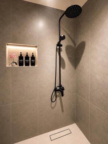 a shower with a shower head in a bathroom at Sukoon Al Jubail in Al Fanātīr