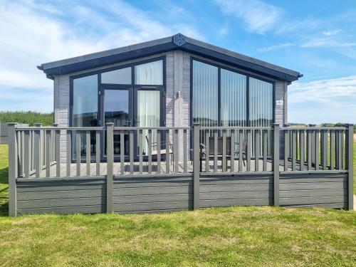 a small house with a balcony with a fence at Cherry Blossom 40 - Uk50709 in Garton