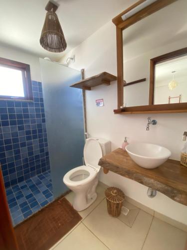 a bathroom with a toilet and a sink and a mirror at Casa Signore Ventoforte in Caucaia