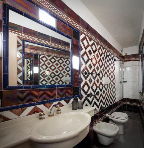 a bathroom with a sink and a toilet at Hotel l'etoile de la ville in Montecatini Terme