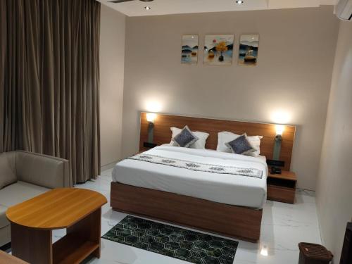 a hotel room with a bed and a table and a chair at Yash Residency in Bharāwās