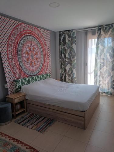 a bedroom with a bed and a large rug at Apartment with terrace in Vinarós