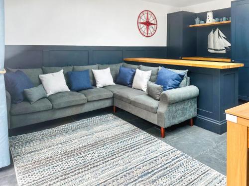 a couch and a chair in a living room at The White Anchor in Newborough