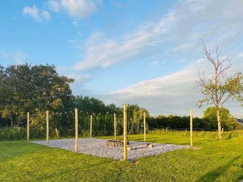 a park with a bench and poles in the grass at The White Anchor in Newborough