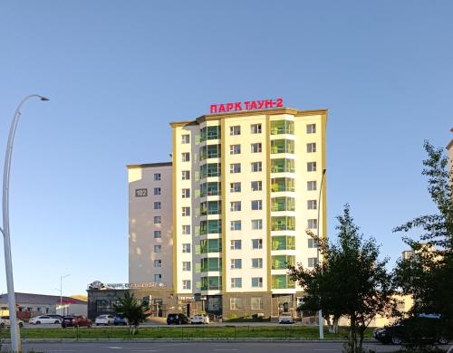 a hotel tower with a sign on top of it at Darkhan apartment in Darhan