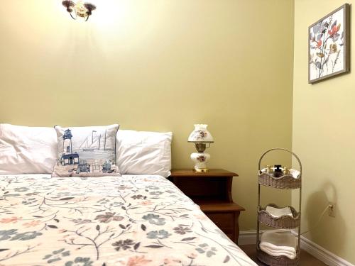 a bedroom with a bed with a floral bedspread at Private Guest Suit-Self Checkin-Near Downtown in Charlottetown