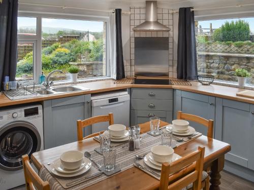 a kitchen with a table with chairs and a sink at New House Farm - Ukc6912 in Leck