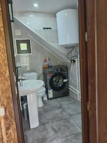 a small bathroom with a sink and a washing machine at Tsiskari in Tsaldashi