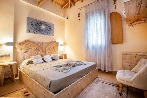 a bedroom with a large bed with a wooden headboard at Nous Village 2 in Alyki