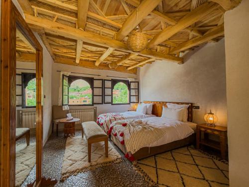 a bedroom with a large bed and a wooden ceiling at Tonaroz House in Imlil