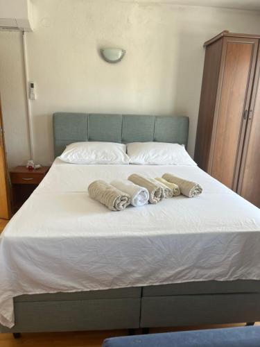 a bed with two towels on top of it at Casa Marelia - studio A2 in Primošten