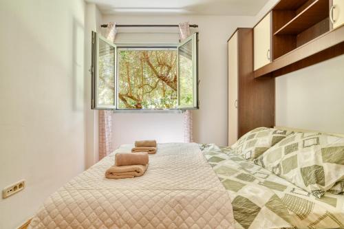 a bedroom with a bed with two towels on it at Apartments Moskov in Kotor