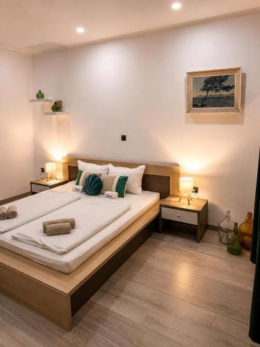 a bedroom with a large bed and two night stands at Holiday house Marea in Bribir