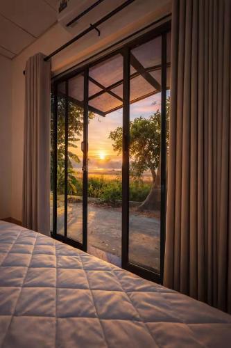 a bedroom with a bed and a window with a view at Trump House in Anuradhapura