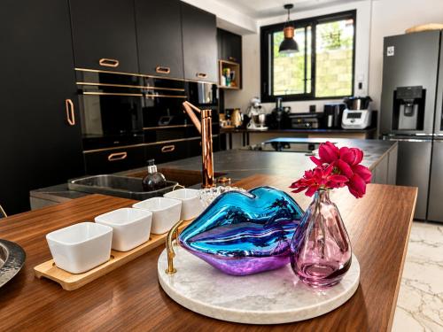 a kitchen with a table with a vase with a flower in it at Contemporary villa between Paris and Disneyland in Champs-sur-Marne