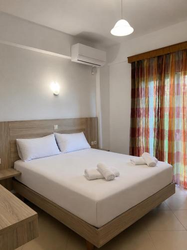 a bedroom with a bed with two towels on it at Kloen Sunset Villa in Sarandë