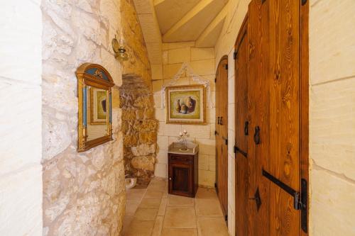 a bathroom with a sink and a mirror at Ta' Kullarina Farmhouse in Żebbuġ