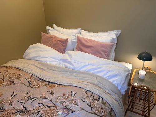 a bed with pillows on it in a room at Old Town Loft Middelfart in Middelfart