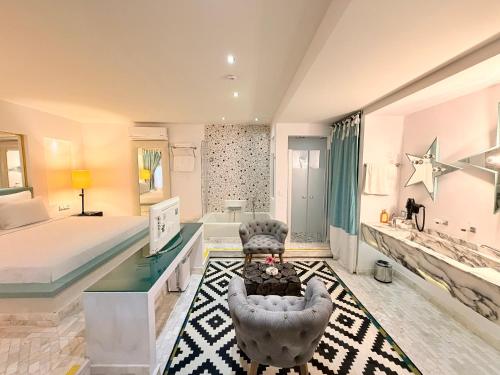 a hotel room with a bed and a bed and a desk at Marge Hotel Adult Only 12 plus in Ilıca