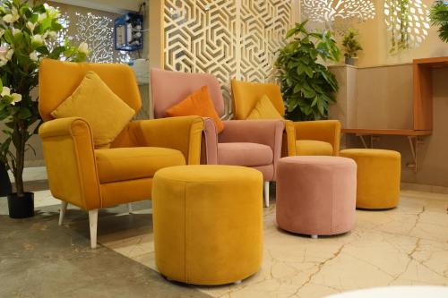 a group of chairs and ottomans in a store at Aurelia INN - JP Nagar in Bangalore