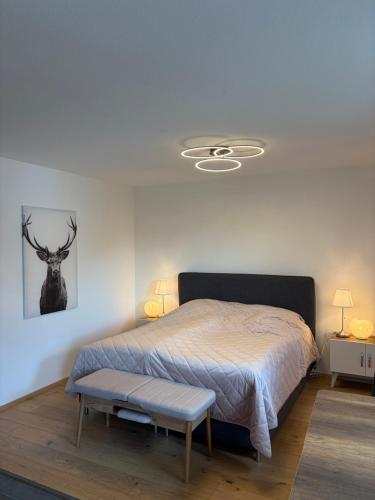 a bedroom with a bed and a bench in it at Ferienwohnung Alpensteinbock in Nesselwang