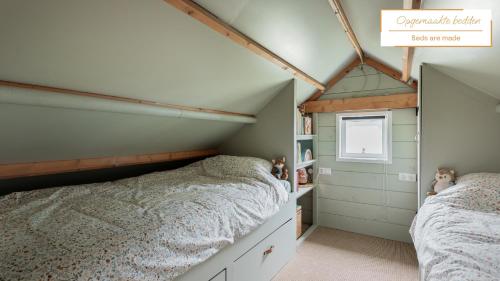 a bedroom with two beds and a window at Boshuis Luna | 4 persons in Gasselte