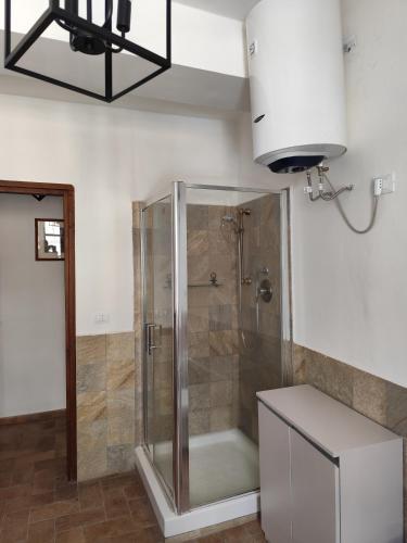 a shower with a glass door in a bathroom at Casa Yos in Vallerano