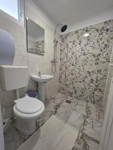 a bathroom with a toilet and a sink at Casa Ana Maria in Vama Veche